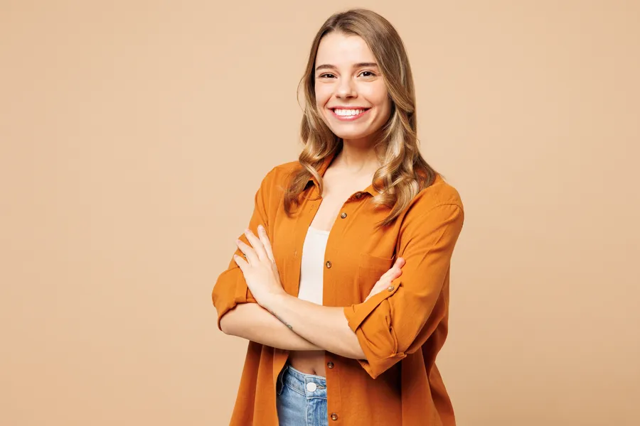 Smiling woman wearing an orange blouse